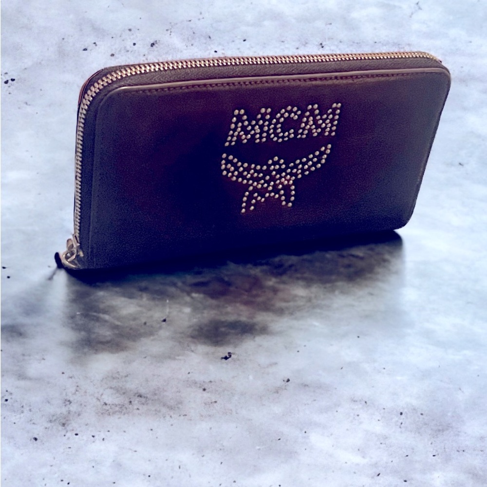 Auth. MCM vintage black leather wallet, zip closure and studded logo.